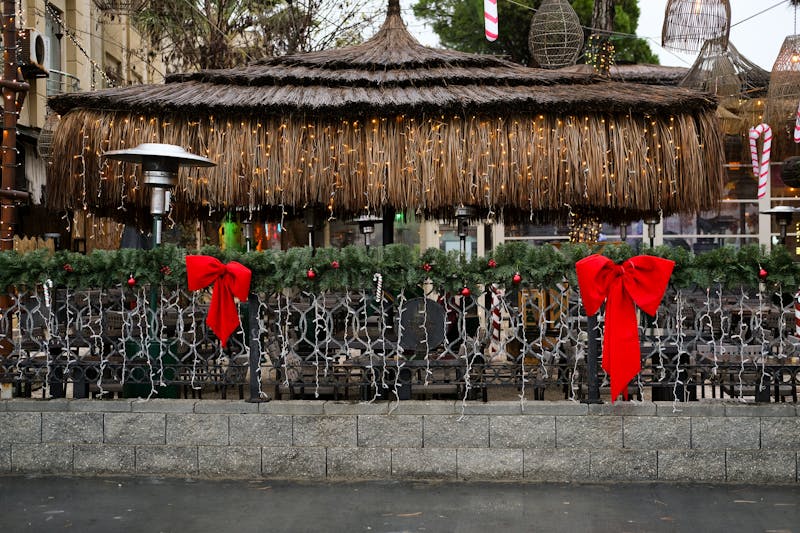 Sunny outdoor terrace with bistro tables and string lights